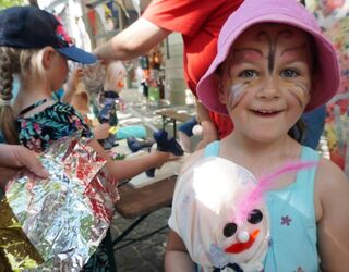 Ein geschminktes Kind auf einem Kinderfest.